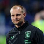 Liam Manning sa prizerá počas zápasu Huddersfield