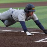 Lavičky sa uvoľňujú počas univerzitného bejzbalového zápasu po náročnom zápase