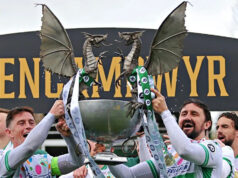 Mooney z FAW nadšený z opätovného spustenia Cymru Premier Grafika zobrazujúca 16 tímov v Cymru Premier 2026-27 spolu s trofejou