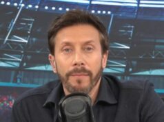 Sam Matterface oznamuje smrť otca vo vysielaní za „náhle a šokujúce okolnosti“ Jednotlivec s bradou, oblečený v tmavej košeli s dlhým rukávom, vyzerá ako zapojený do rozhovoru. Mikrofón je umiestnený pred osobou a na pozadí je rozmazané zobrazenie toho, čo vyzerá ako športové miesto.