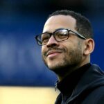 Jednotlivec, ktorý si nasadí čiernu bundu a okuliare, vyžaruje sebavedomé vystupovanie, keď stojí na športovom ihrisku, prípadne sa venuje pozorovaniu prebiehajúcej udalosti.