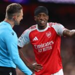 Noni Madueke sa rozpráva s rozhodcom Danielom Siebertom počas druhého semifinálového zápasu Ligy majstrov UEFA 2025/26 medzi Arsenalom FC a Atleticom de Madrid.