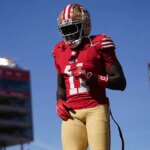 San Francisco 49ers široký prijímač Brandon Aiyuk kráčajúci po ihrisku na Levi's Stadium.