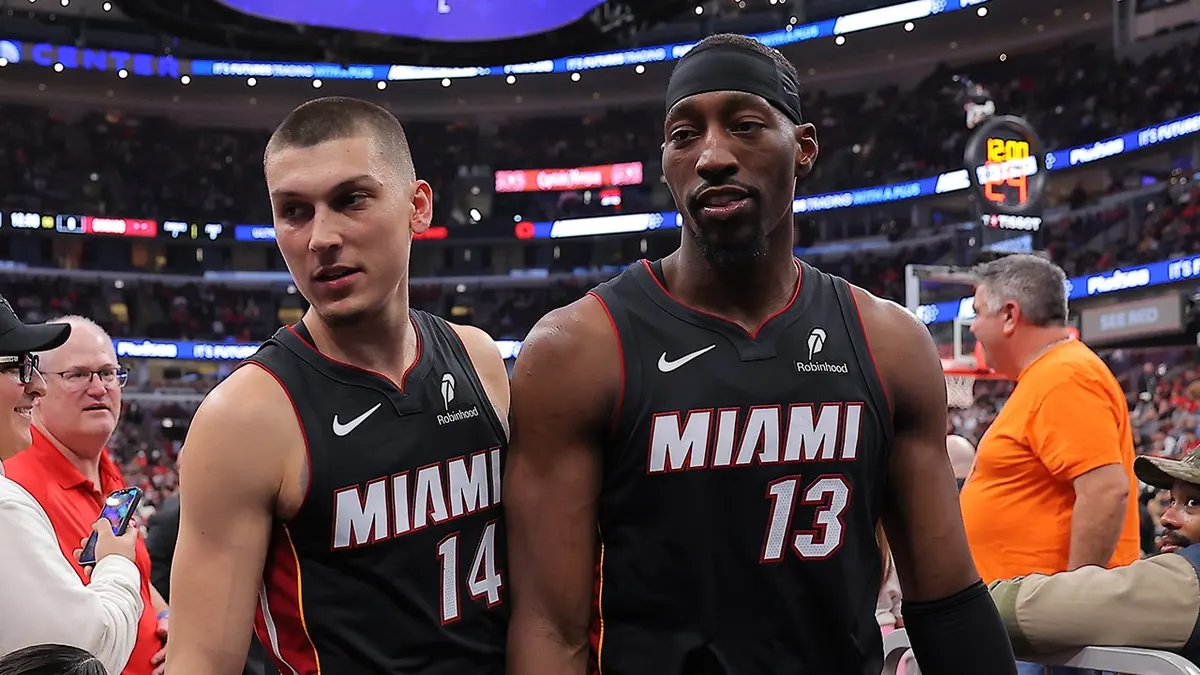 Bam Adebayo a Tyler Herro opúšťajú kurt v United Center.