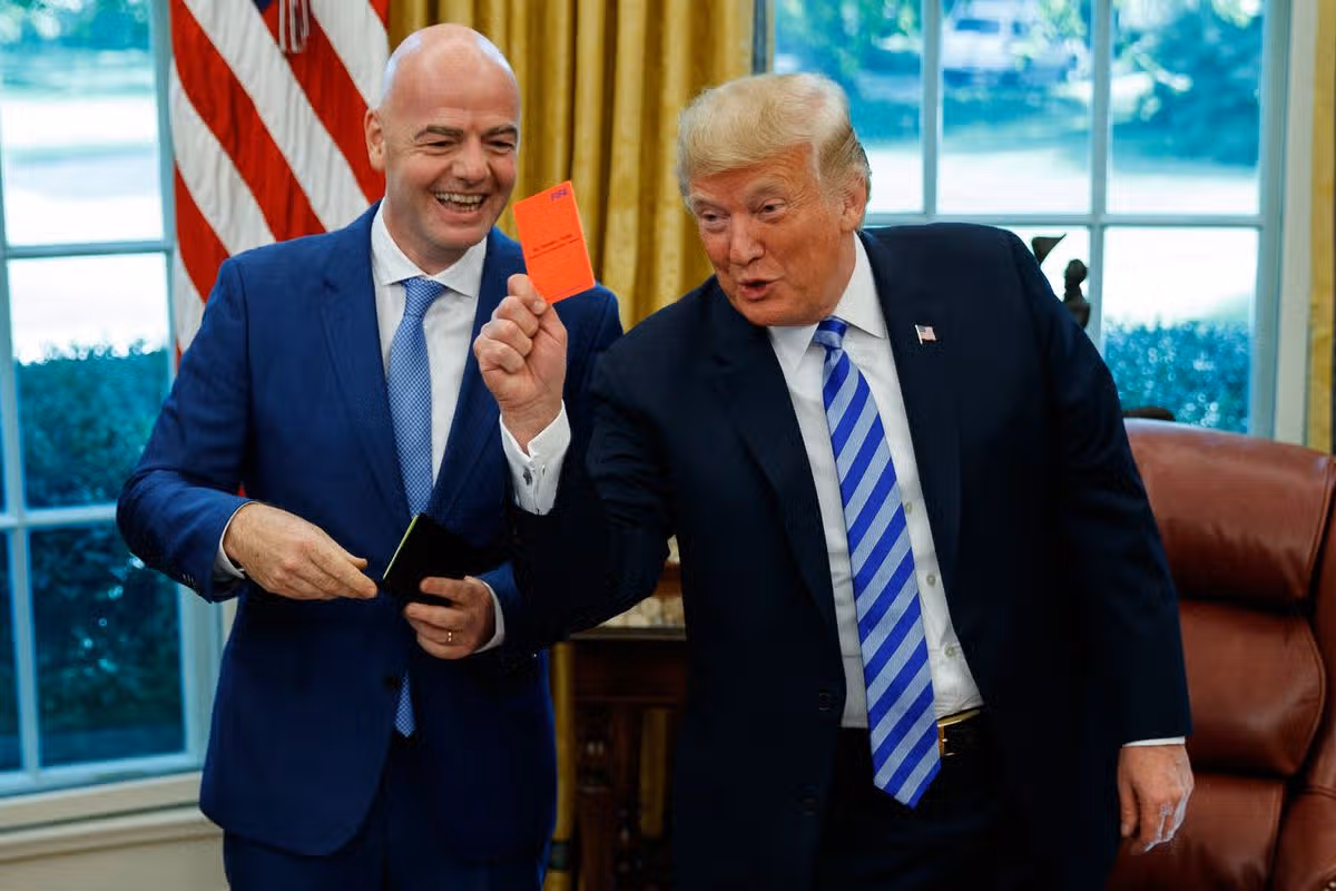 SÚBOR - Prezident Donald Trump drží červenú kartu počas stretnutia s prezidentom FIFA Giannim Infantinom v Oválnej pracovni Bieleho domu v utorok 28. augusta 2018 vo Washingtone. (AP Photo/Evan Vucci, súbor)