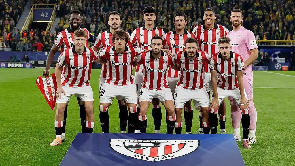 Futbalový tím Athletic Bilbao pózuje na fotografii so svojím logom v popredí.